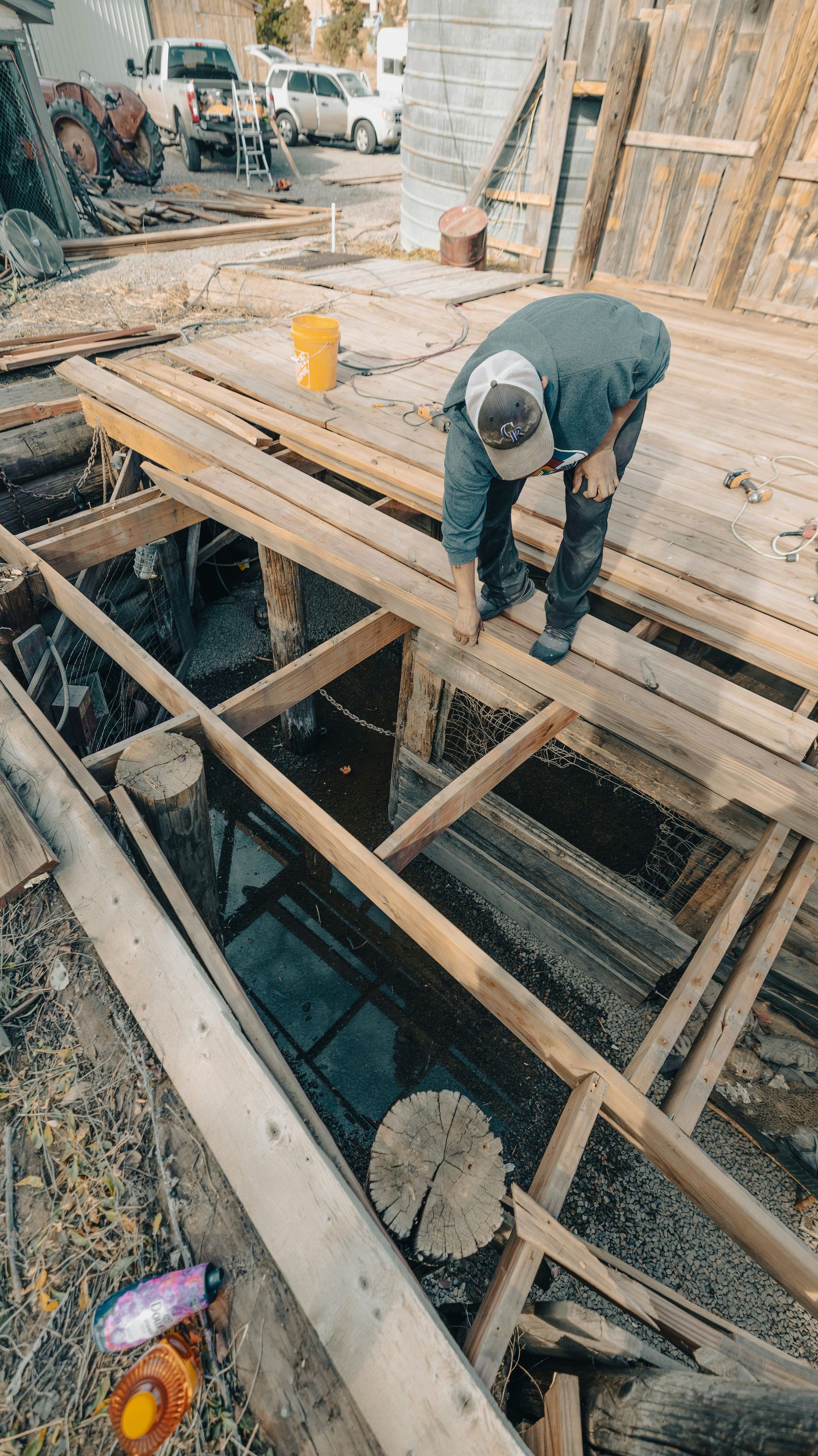 Man working on wooden structure over water