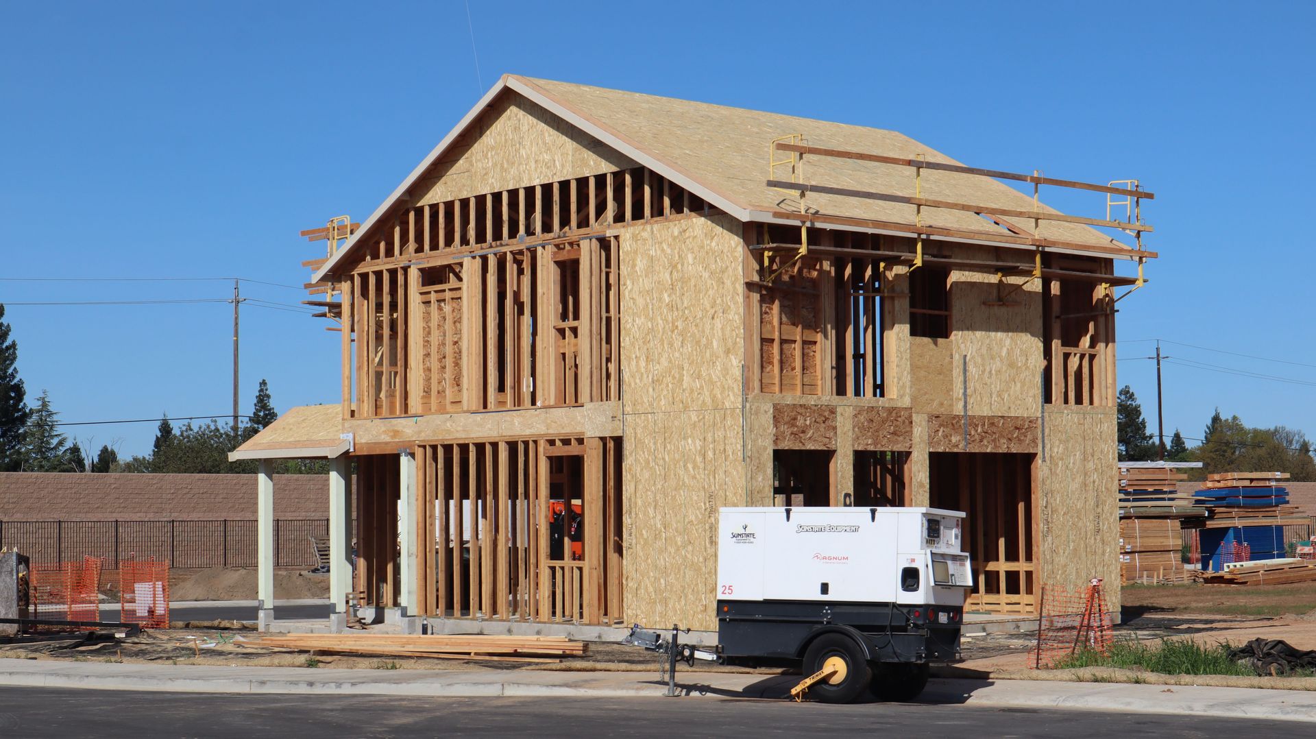 A new house under construction in Elk Grove, showing wooden framing and building materials.